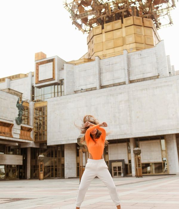 Woman feeling energetic and calm in a bright, open space.